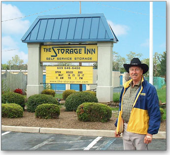 Rudy Meckel poses in front of The Storage Inn of Egg Harbor Township with the trademark carriage